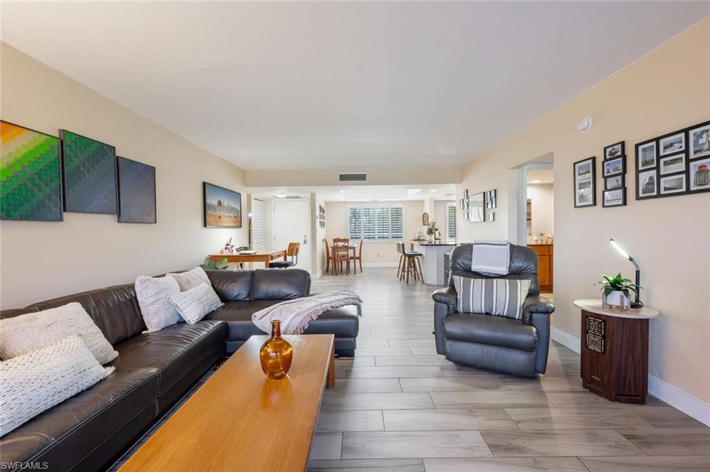 413 Augusta Boulevard, Unit 302 Naples, FL 34113 - Photo 7 of 39 a living room with furniture and a couch