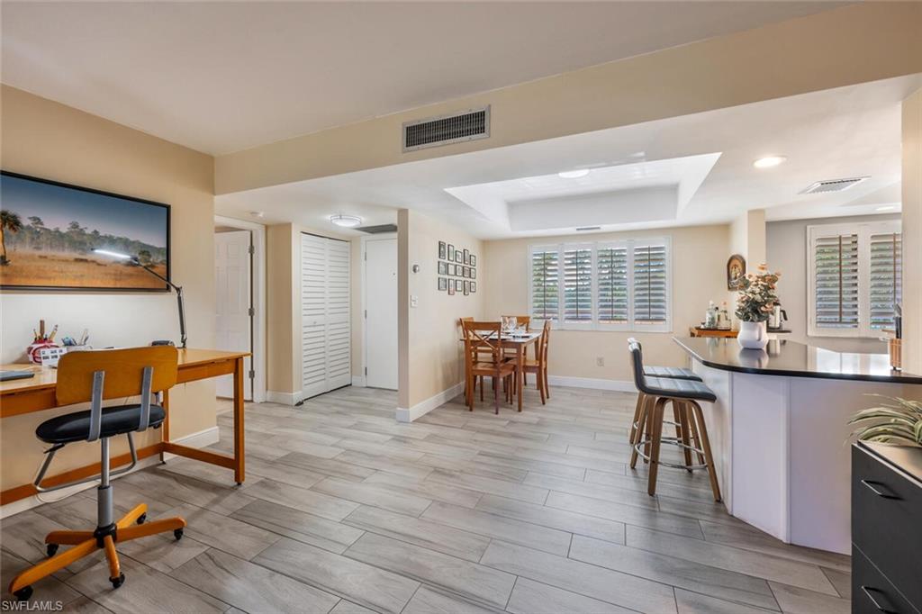 413 Augusta Boulevard, Unit 302 Naples, FL 34113 - Photo 8 of 39 a dining room with furniture and wooden floor
