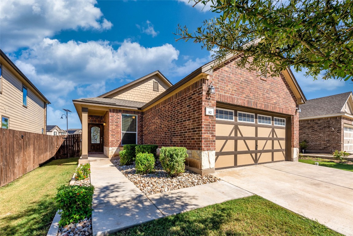 2950 East Old Settlers Boulevard, Unit 82 Round Rock, TX 78665 - Photo 1 of 31 a front view of a house with a yard and garage
