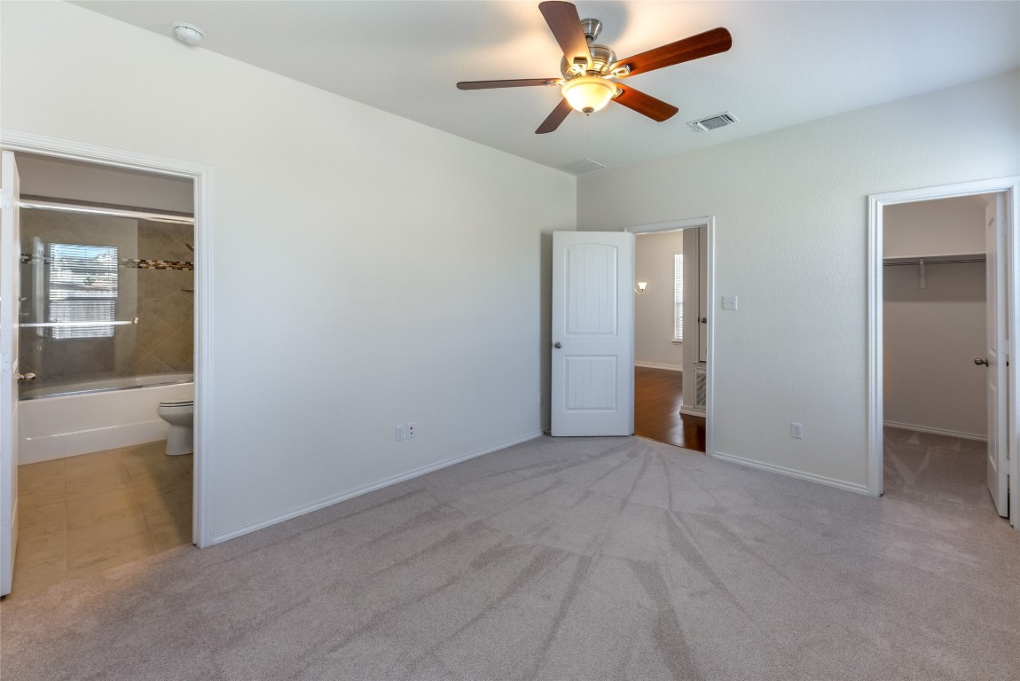 2950 East Old Settlers Boulevard, Unit 82 Round Rock, TX 78665 - Photo 11 of 31 an empty room with closet and a chandelier fan