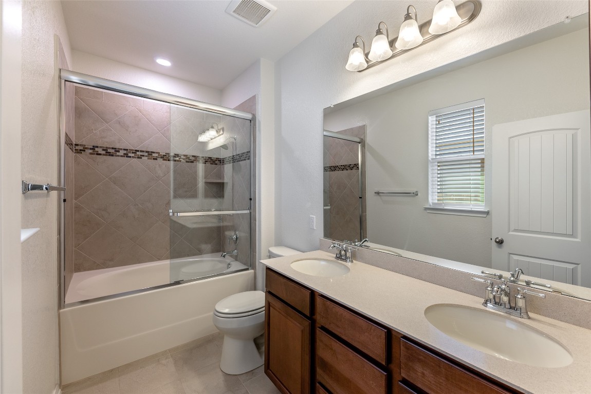 2950 East Old Settlers Boulevard, Unit 82 Round Rock, TX 78665 - Photo 12 of 31 a bathroom with a sink a toilet and shower