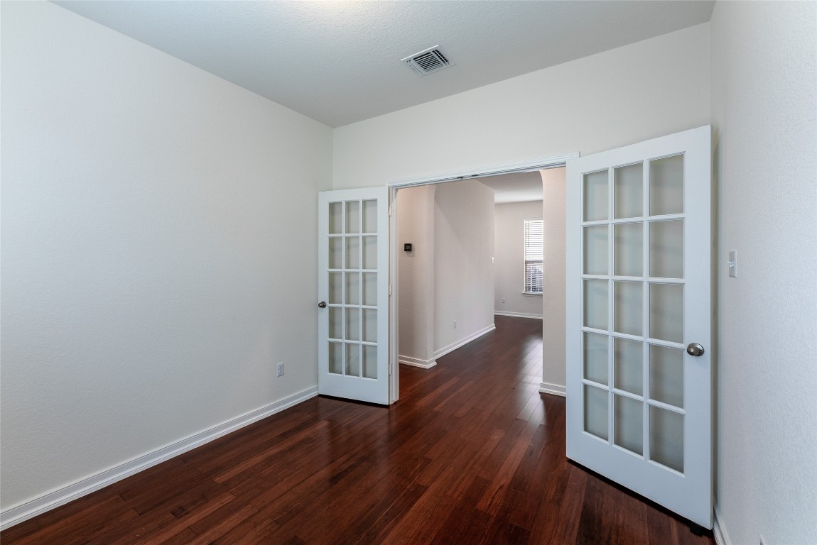 2950 East Old Settlers Boulevard, Unit 82 Round Rock, TX 78665 - Photo 15 of 31 an empty room with wooden floor and closet