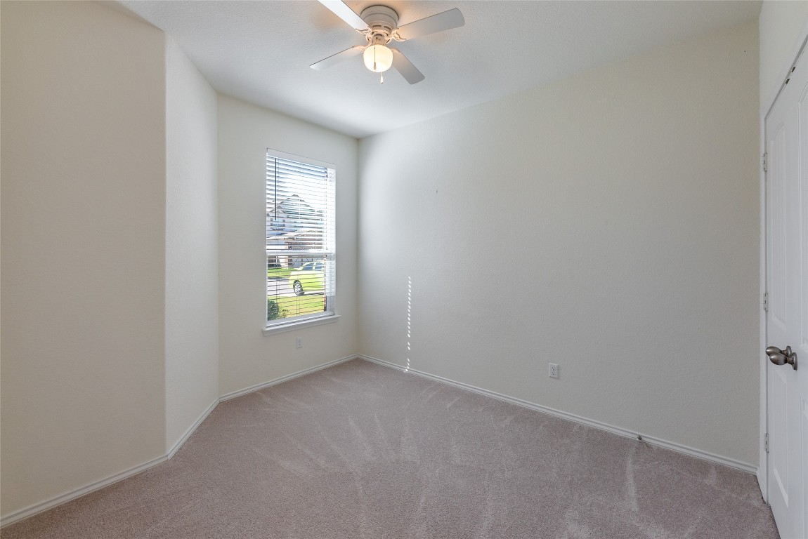 2950 East Old Settlers Boulevard, Unit 82 Round Rock, TX 78665 - Photo 16 of 31 an empty room with window and fan