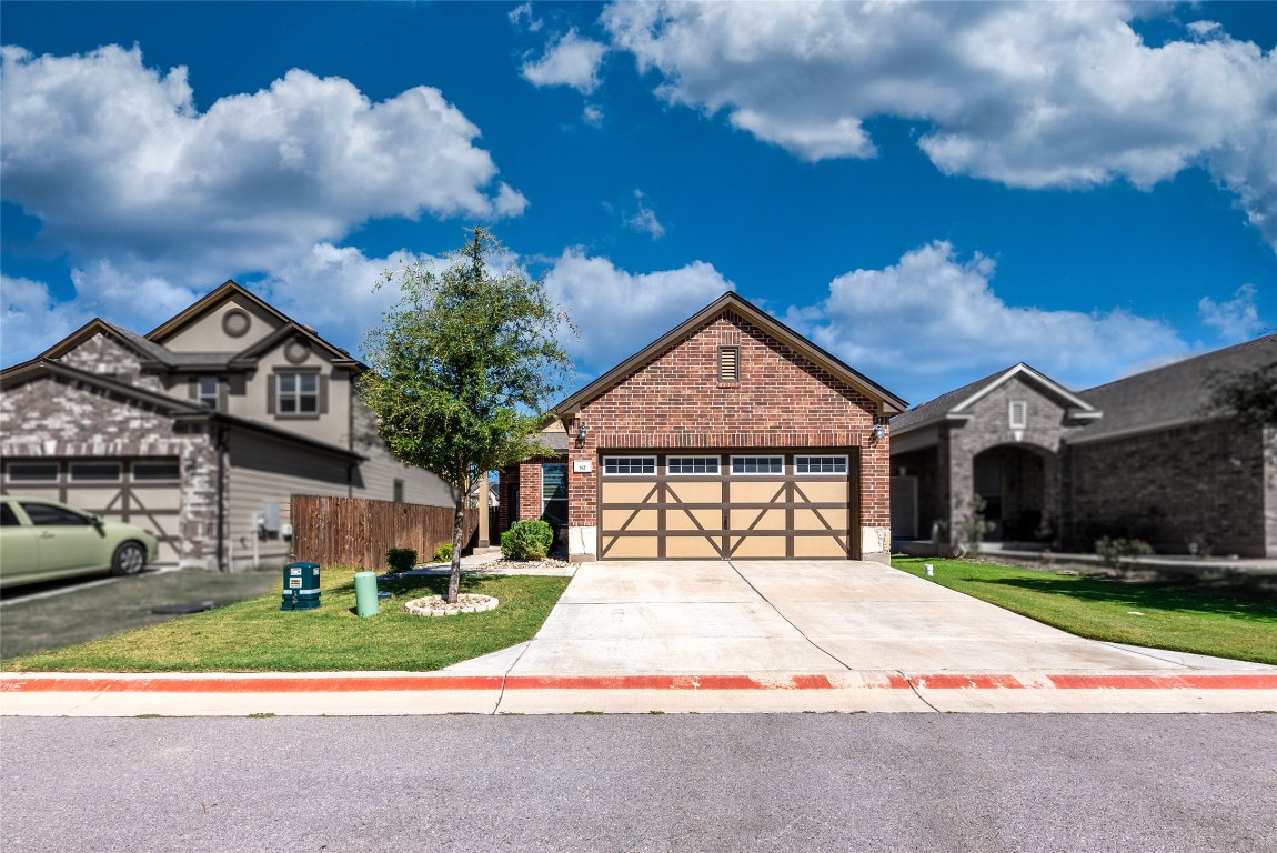 2950 East Old Settlers Boulevard, Unit 82 Round Rock, TX 78665 - Photo 2 of 31 a front view of a house with a garden and pathway