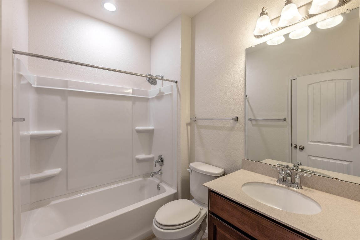 2950 East Old Settlers Boulevard, Unit 82 Round Rock, TX 78665 - Photo 21 of 31 a bathroom with a sink a toilet and shower
