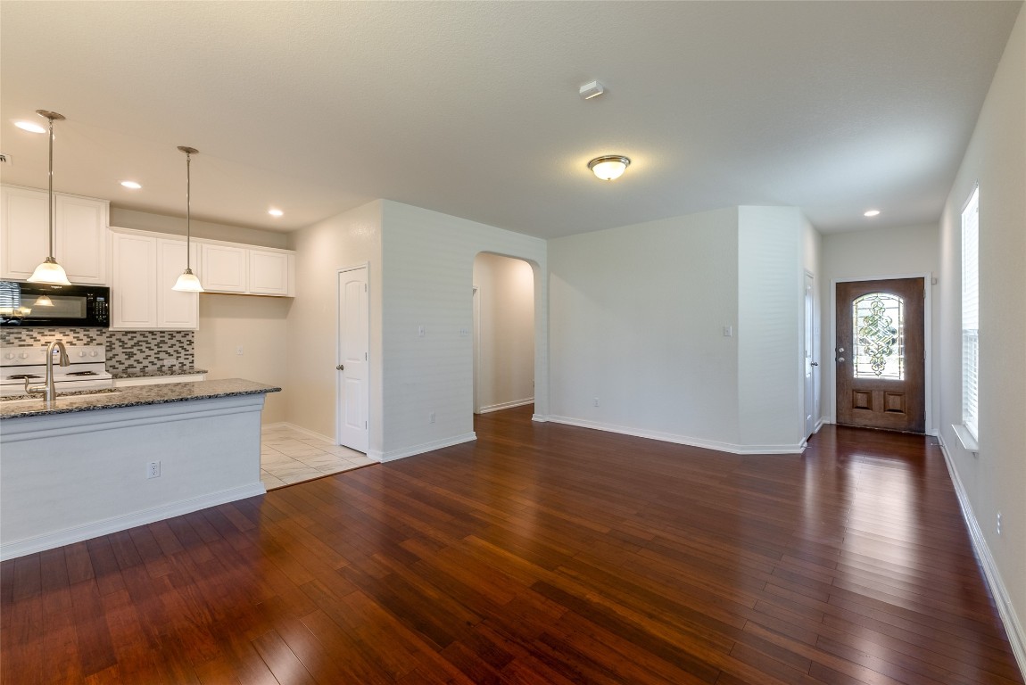 2950 East Old Settlers Boulevard, Unit 82 Round Rock, TX 78665 - Photo 5 of 31 a view of an empty room with window and wooden floor