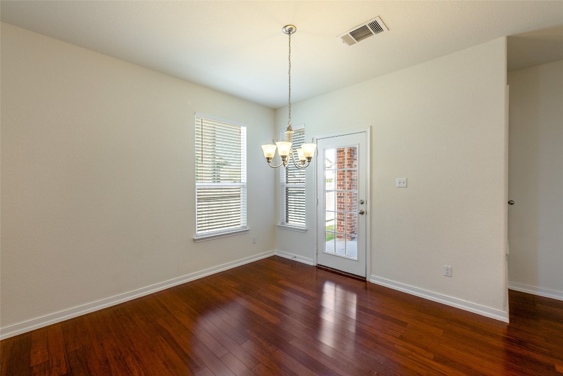 2950 East Old Settlers Boulevard, Unit 82 Round Rock, TX 78665 - Photo 9 of 31 a view of an empty room with wooden floor and a window