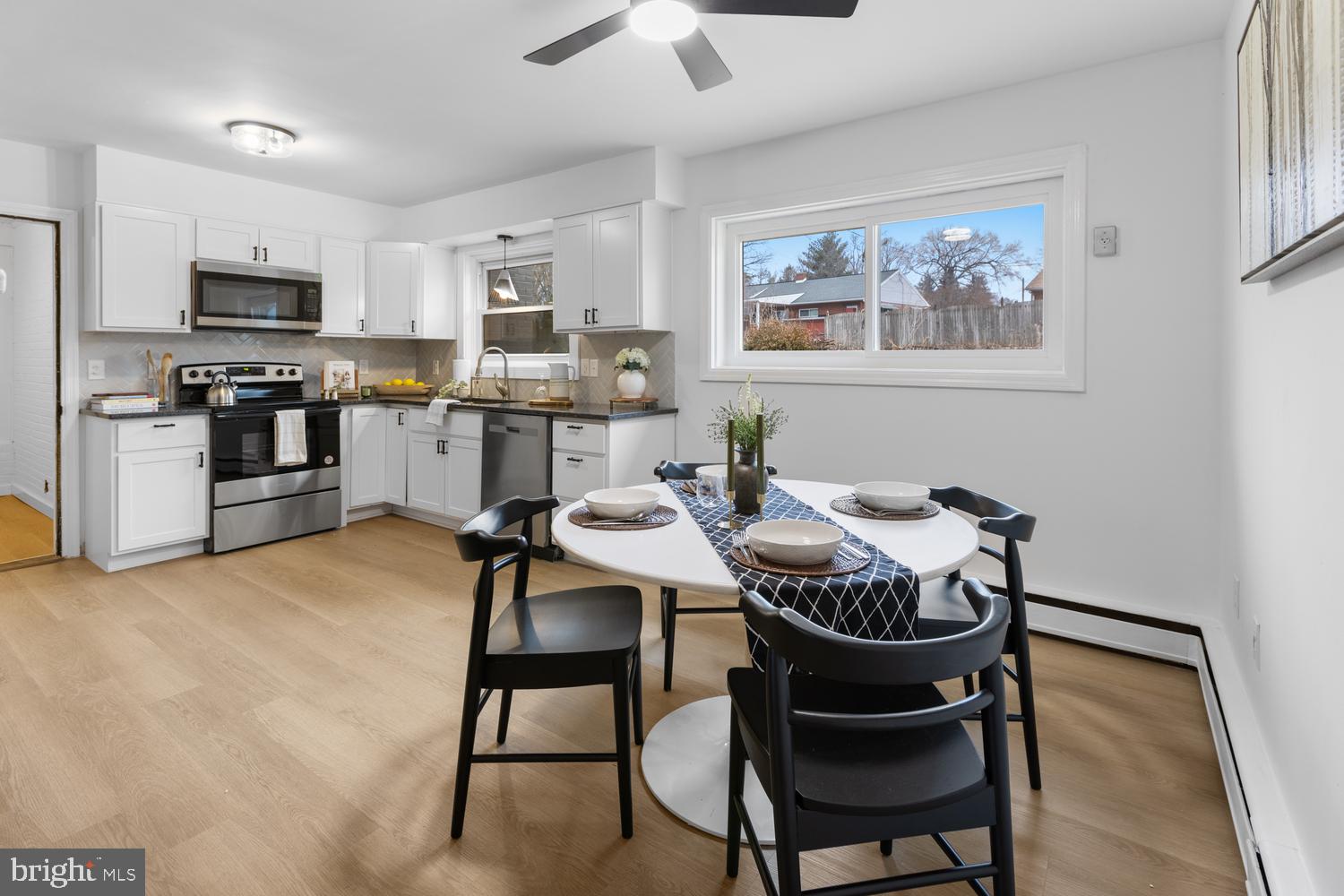 7 Cedarhurst Circle Lancaster, PA 17603 - Photo 6 of 24 a kitchen with stainless steel appliances kitchen island granite countertop a dining table chairs and a refrigerator