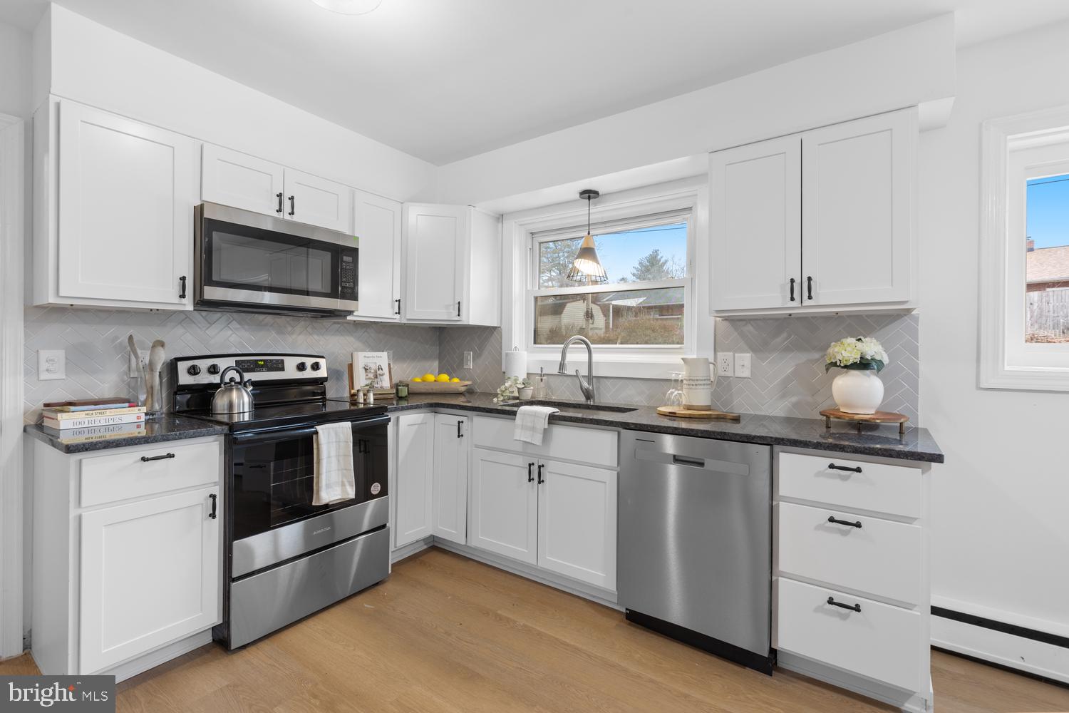 7 Cedarhurst Circle Lancaster, PA 17603 - Photo 7 of 24 a kitchen with stainless steel appliances granite countertop a stove a sink and a microwave