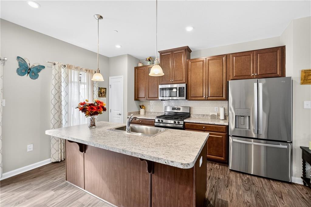 2019 Cade Drive Monaca, PA 15061 - Photo 16 of 37 a kitchen with granite countertop a refrigerator a stove a sink cabinets and wooden floor