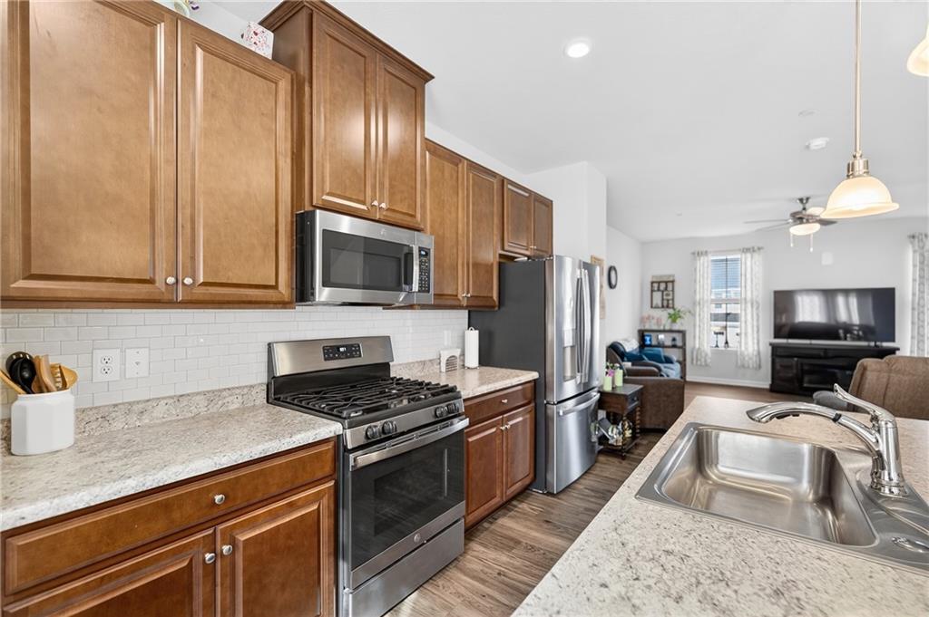 2019 Cade Drive Monaca, PA 15061 - Photo 20 of 37 a kitchen with granite countertop wooden cabinets a stove top oven and stainless steel appliances