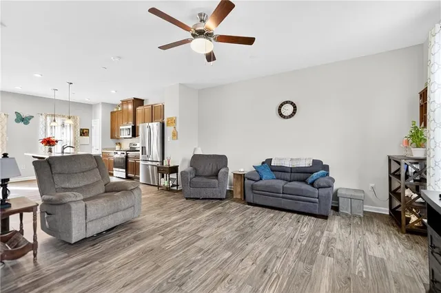 a living room with furniture and a wooden floor