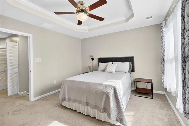 a bedroom with a bed and a ceiling fan
