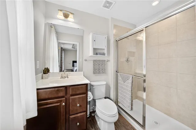 a bathroom with a sink toilet vanity and shower