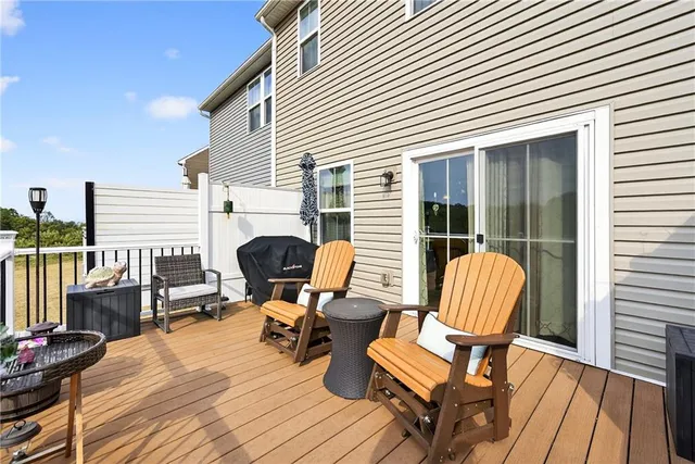 a view of a roof deck with wooden floor and furniture