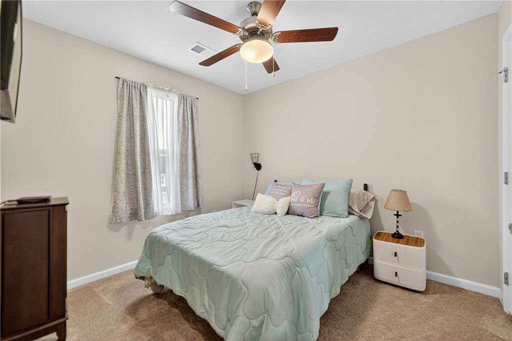 2019 Cade Drive Monaca, PA 15061 - Photo 32 of 37 a bedroom with a bed and a chandelier