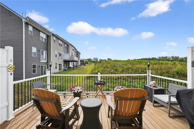 a view of a roof deck with furniture