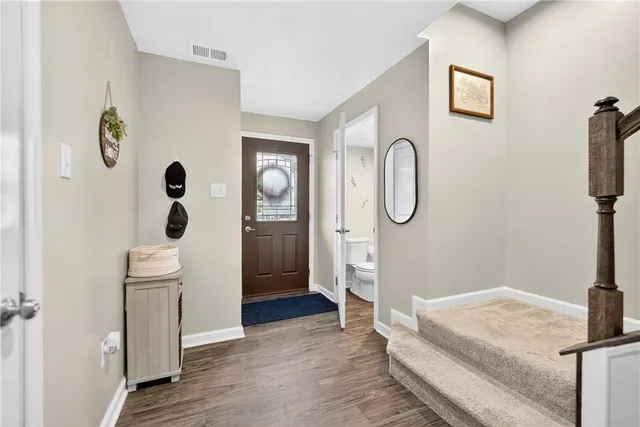 a spacious bedroom with a bed and a chandelier