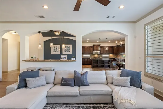 a large kitchen with granite countertop a large center island a stove and a sink