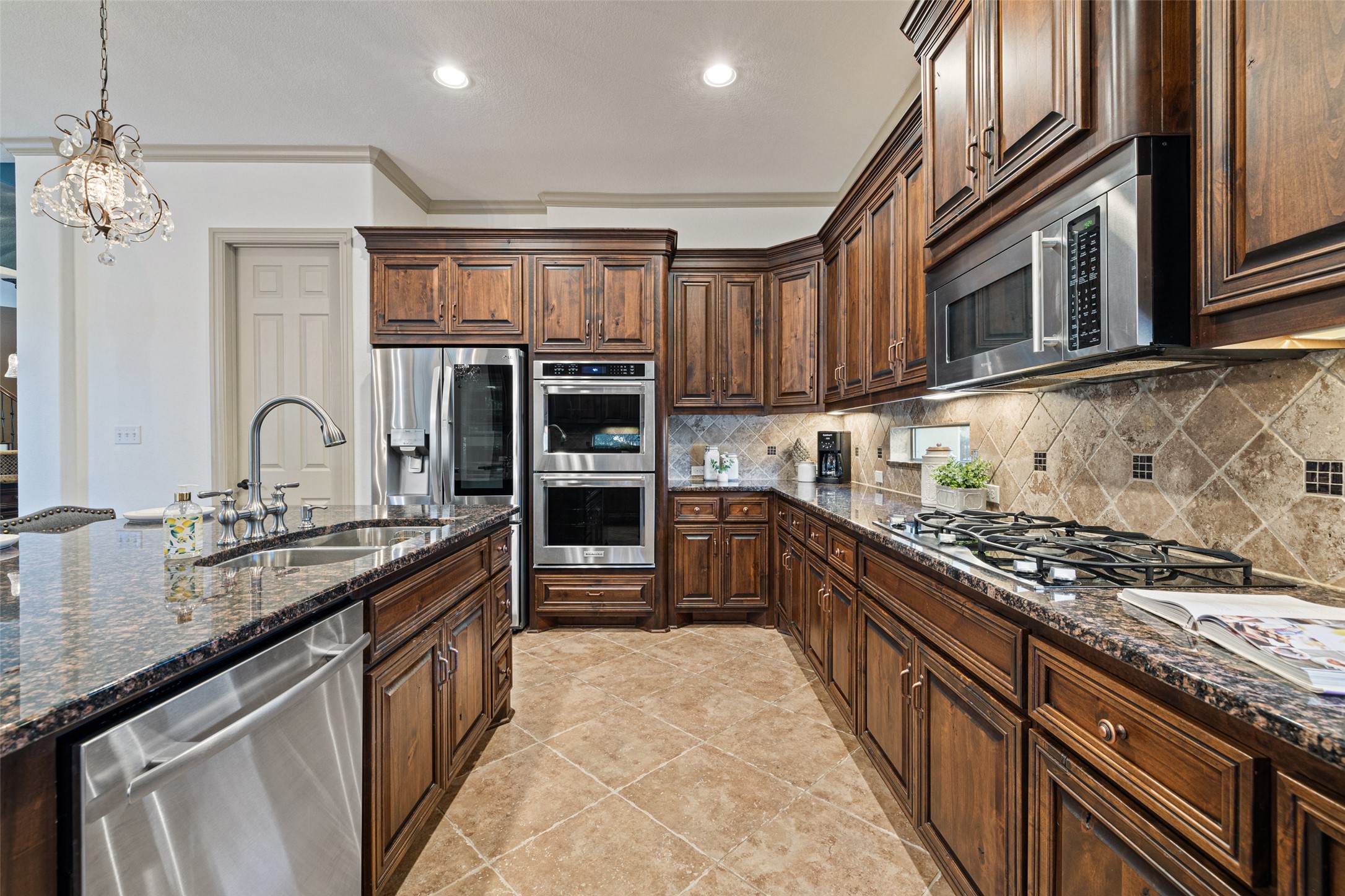 4105 Vail Divide Austin, TX 78738 - Photo 24 of 40 a kitchen with stainless steel appliances granite countertop a stove and cabinets