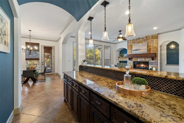 a bathroom with a granite countertop sink a mirror and a bathtub