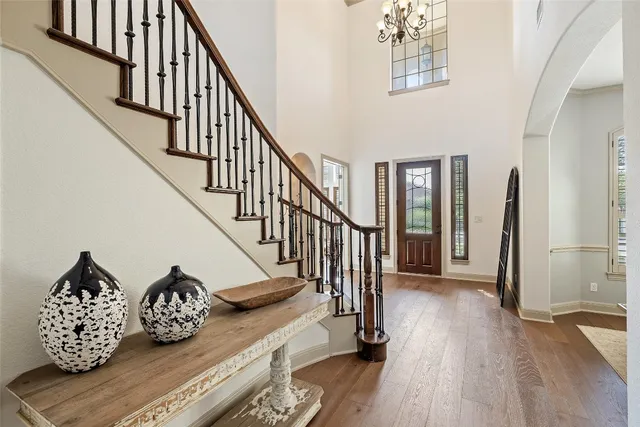 a living room with furniture a chandelier and a window