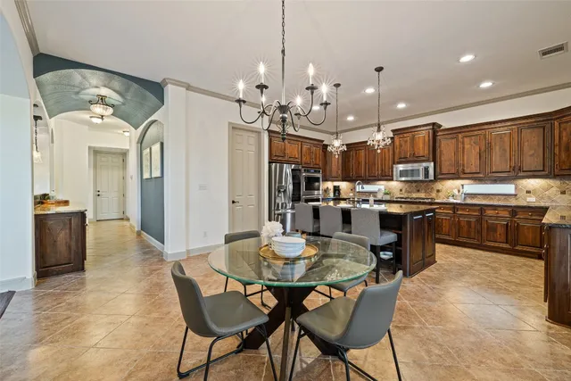 a kitchen with kitchen island a sink stove and refrigerator