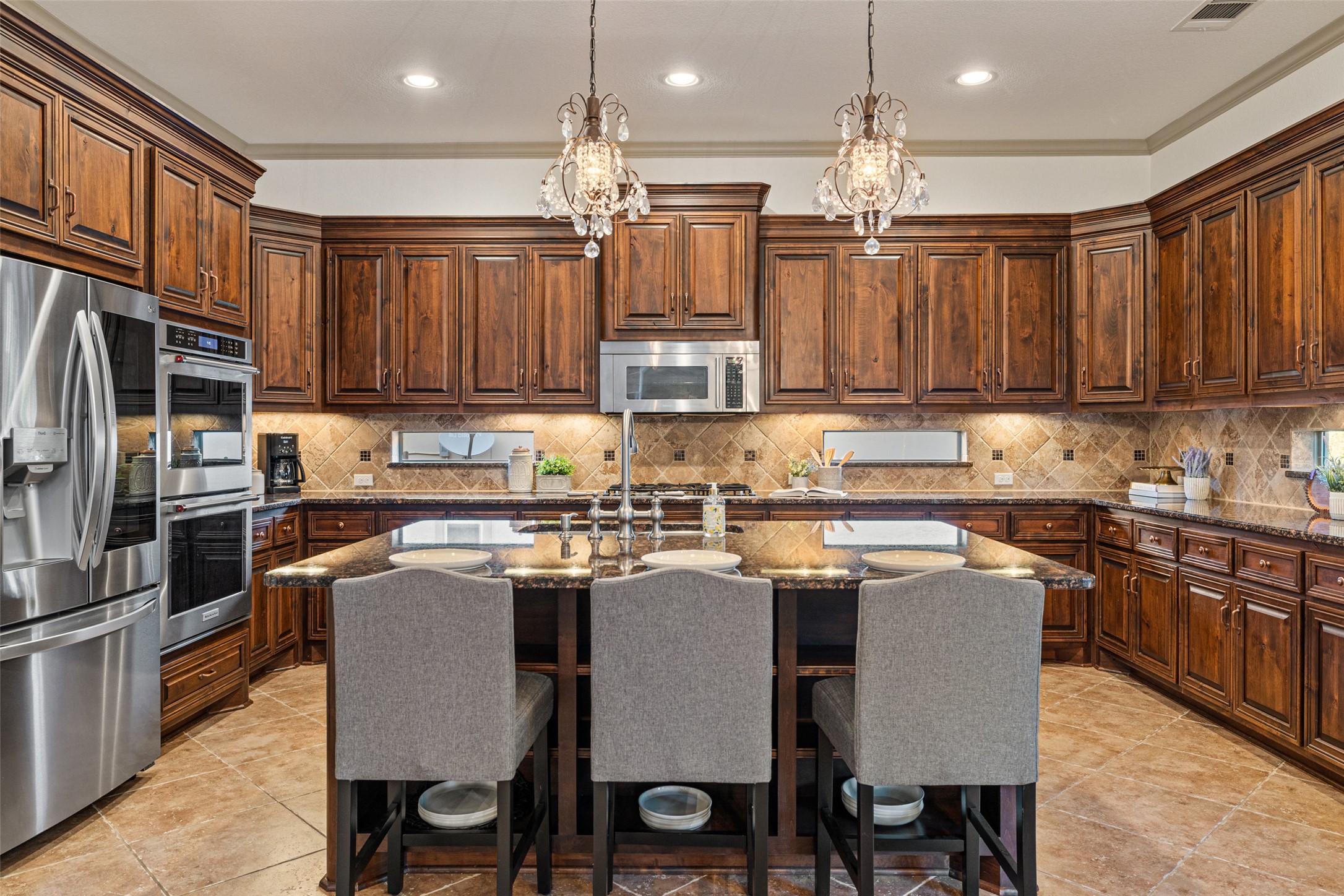4105 Vail Divide Austin, TX 78738 - Photo 9 of 40 a kitchen with kitchen island a sink stove and refrigerator