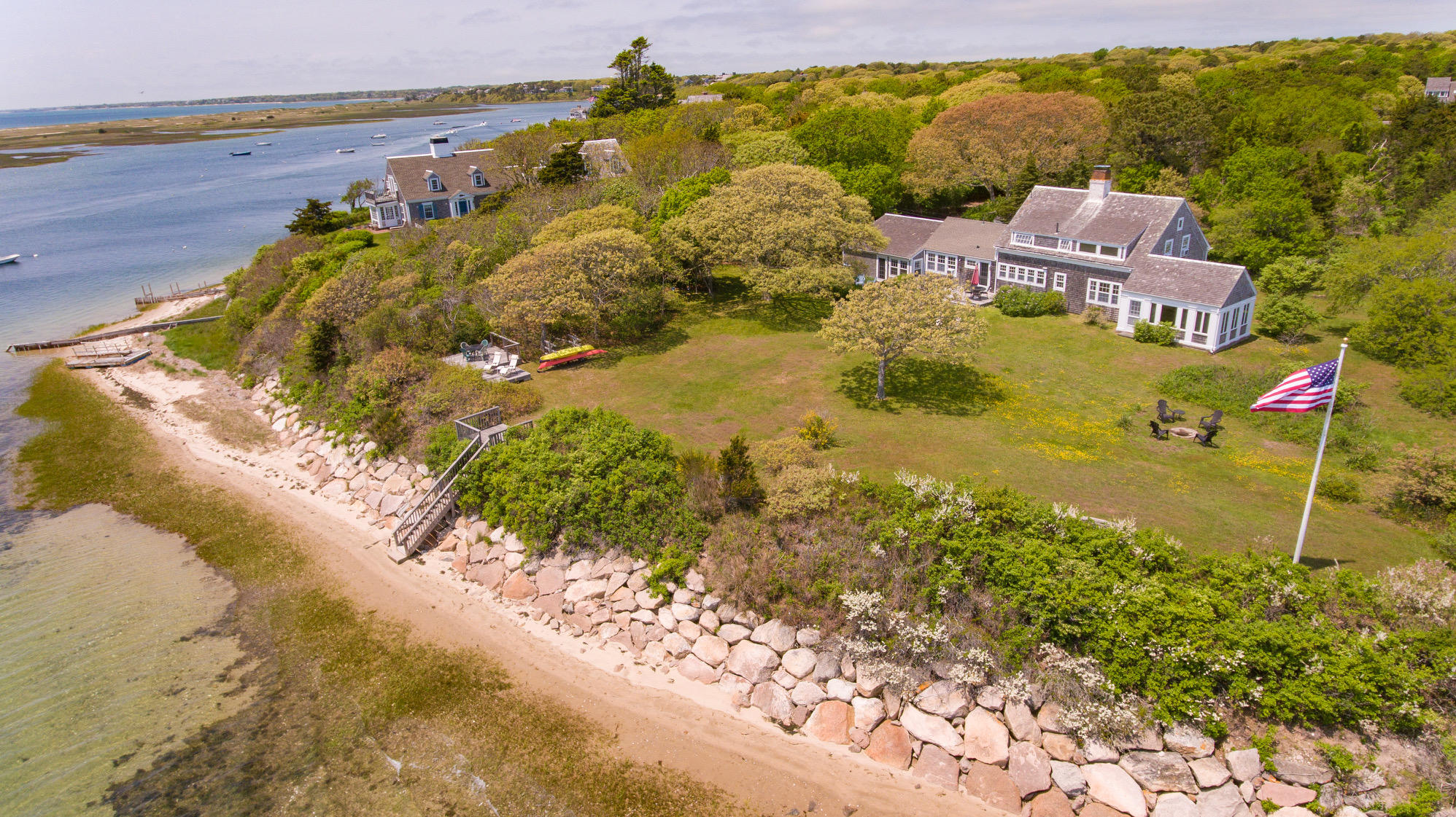 a aerial view of a house with a yard and lake view