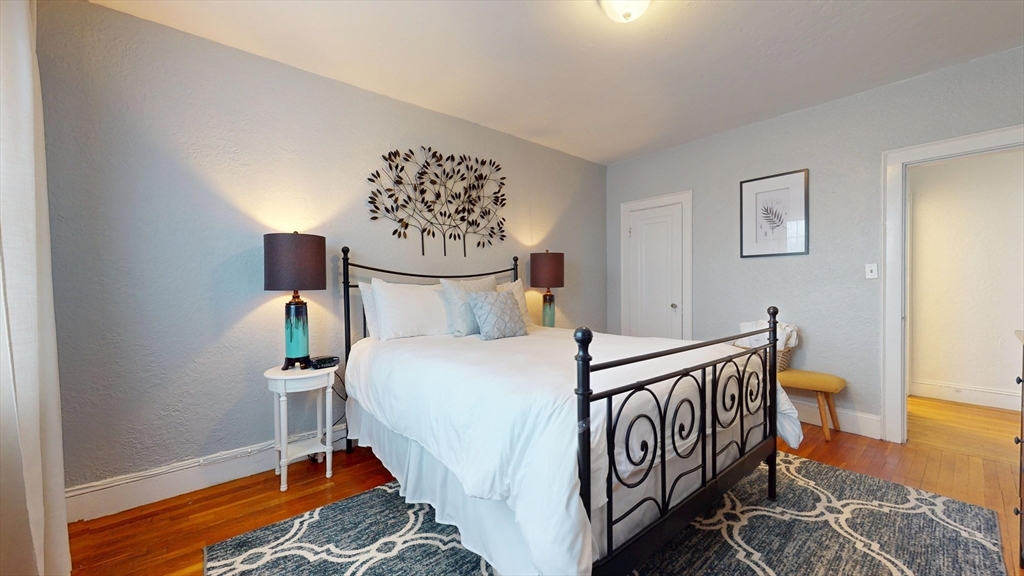 90 Kilsyth Road, Unit 44FURNISHED Boston, MA 02135 - Photo 8 of 10 a bedroom with a bed and a table in it