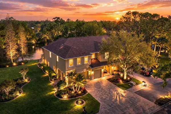 an aerial view of a house with a yard basket ball court and outdoor seating
