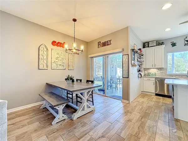 a kitchen with granite countertop a stove a sink dishwasher and a refrigerator