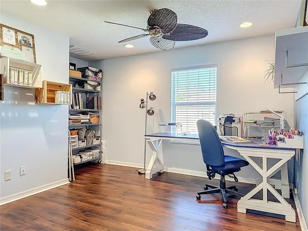 a view of a workspace with furniture and a window