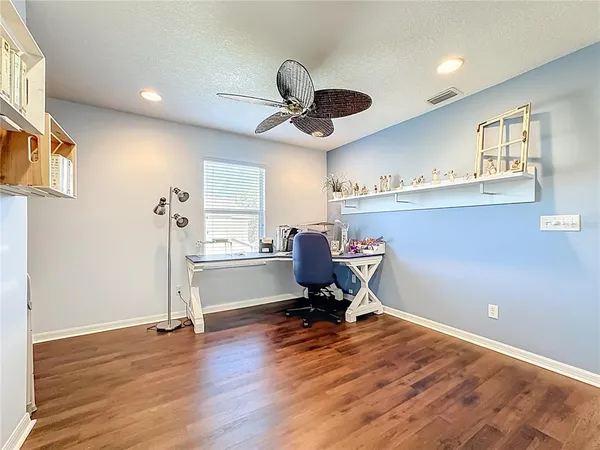 a view of a workspace with furniture and a window
