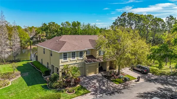 an aerial view of a house with yard