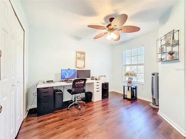 a view of a workspace with furniture and a window