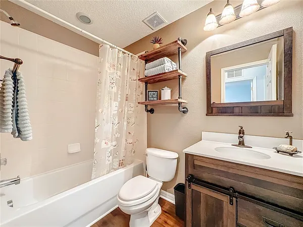 a bathroom with a sink toilet and shower