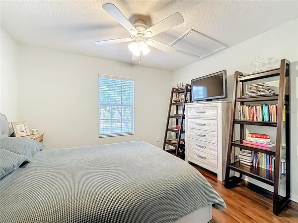 a bedroom with a bed and a flat tv screen