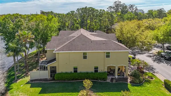 a aerial view of a house with swimming pool garden and lake view