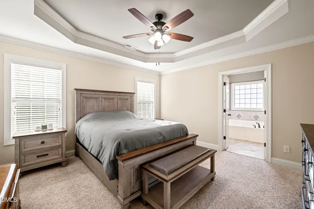 a spacious bedroom with a bed and a ceiling fan