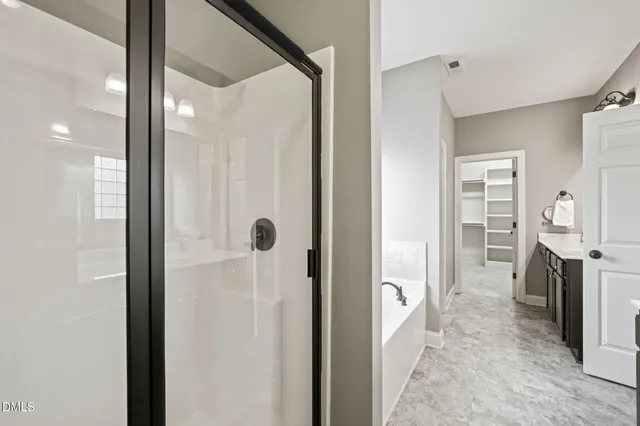 a bathroom with a shower and a mirror