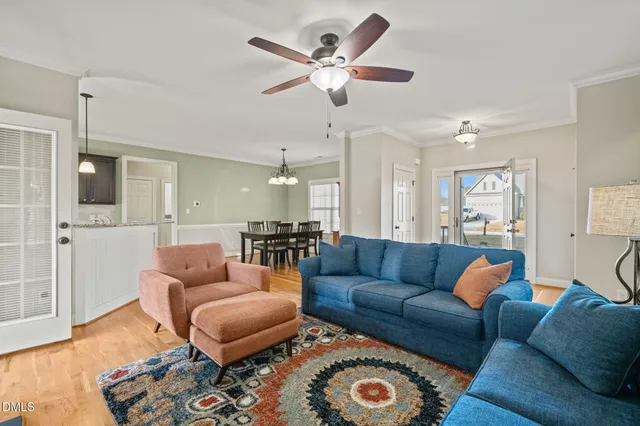 a living room with furniture and wooden floor