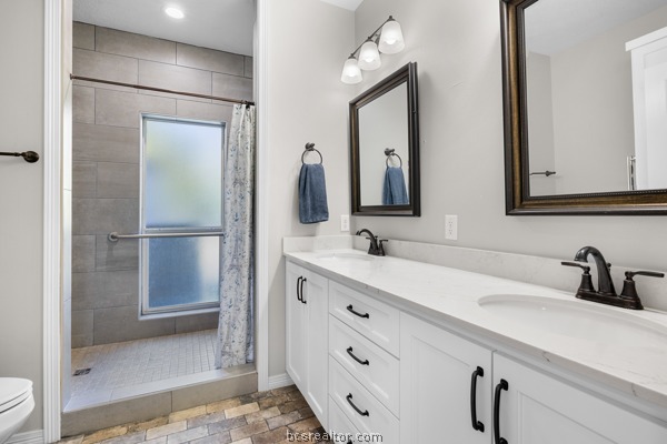 12 Raven's Nest Bryan, TX 77808 - Photo 20 of 46 a bathroom with a double vanity sink mirror and shower