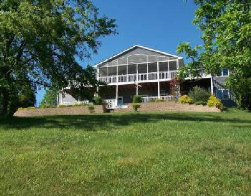 1194 Carters Island Road Goodview, VA 24095 - Photo 5 of 5 a front view of a house with a yard table and chairs