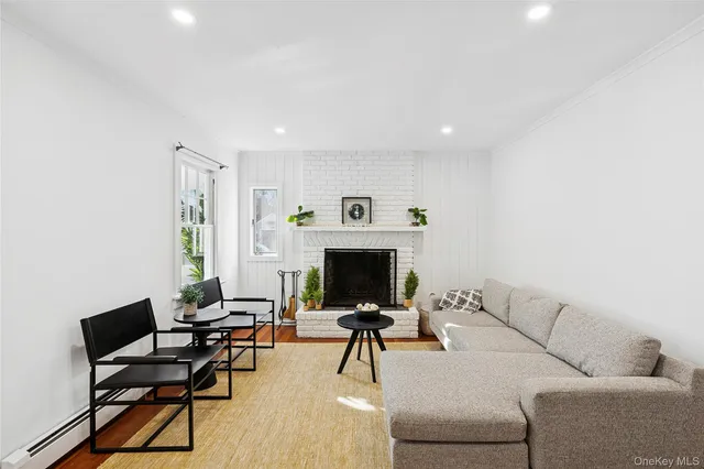 a living room with furniture a fireplace and a table