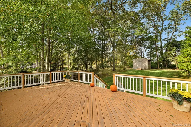 a view of a wooden deck and a yard