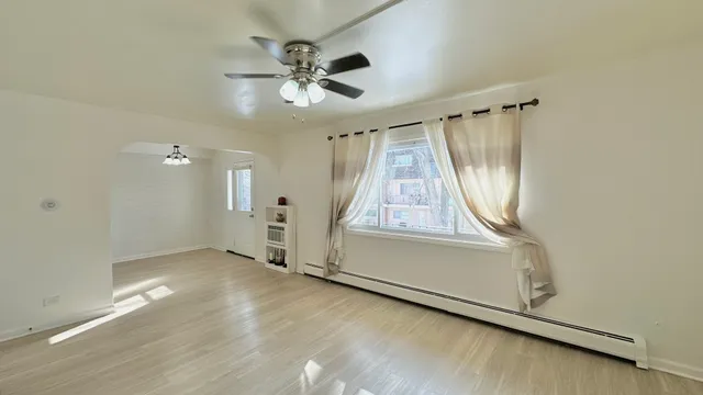 a kitchen with stainless steel appliances granite countertop a stove a refrigerator a sink a dining table and chairs