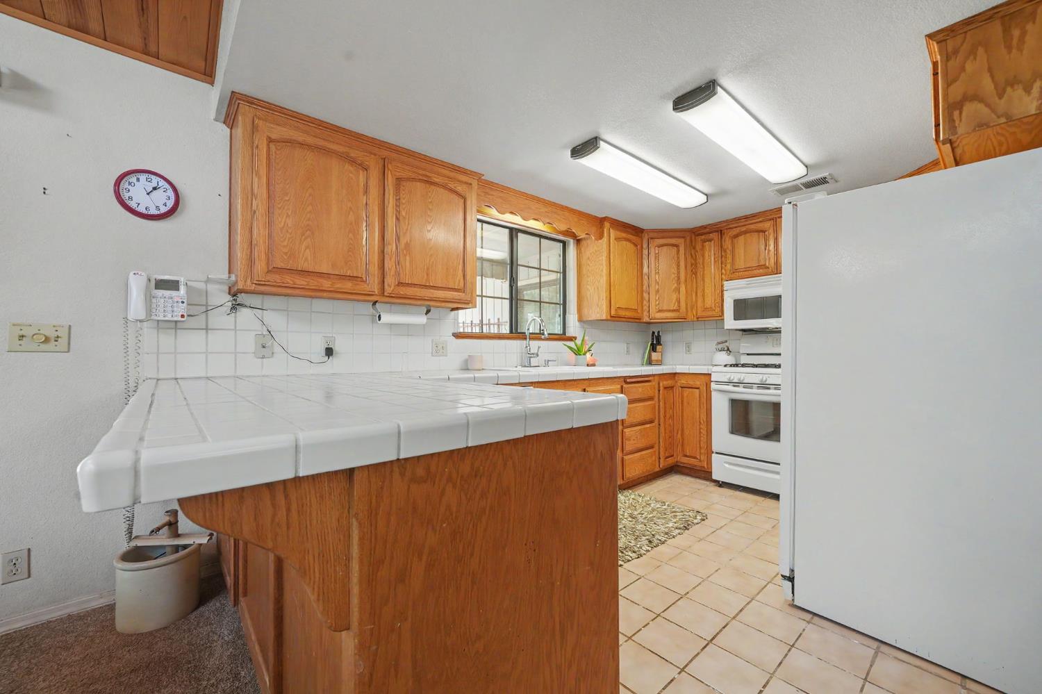 20310 State Rte 26 West Point, CA 95255 - Photo 15 of 57 a kitchen with stainless steel appliances a sink a stove a refrigerator cabinets and a window