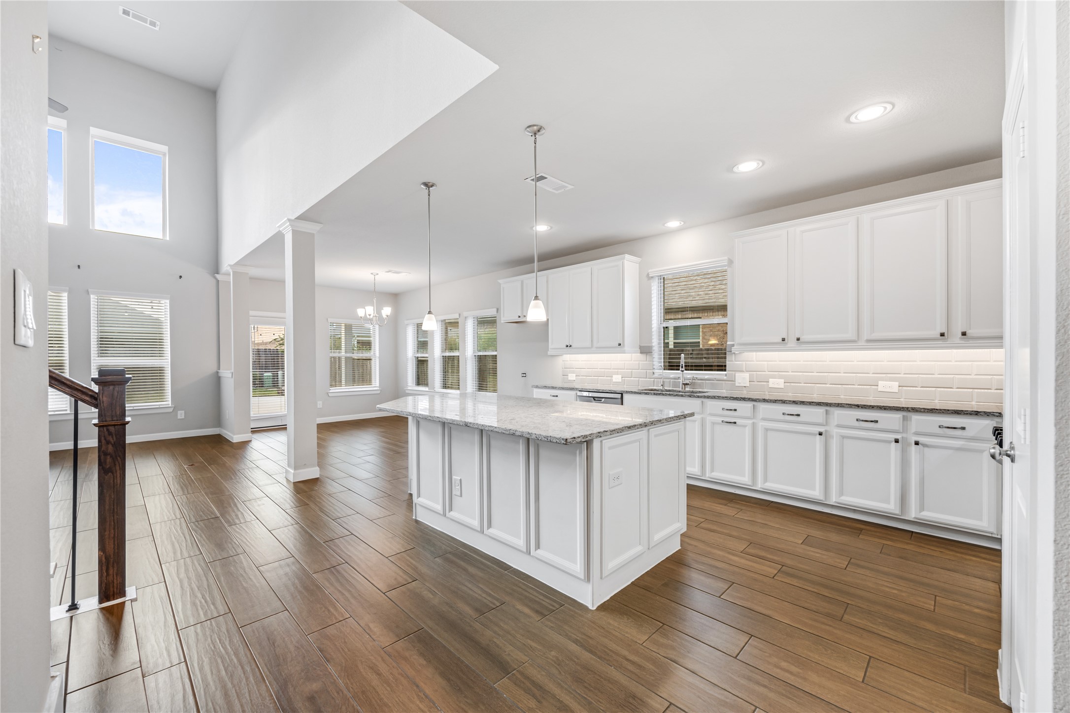 3604 Magnolia Crest Lane Spring, TX 77386 - Photo 12 of 50 a kitchen with stainless steel appliances granite countertop a stove top oven a sink a refrigerator white cabinets and wooden floor