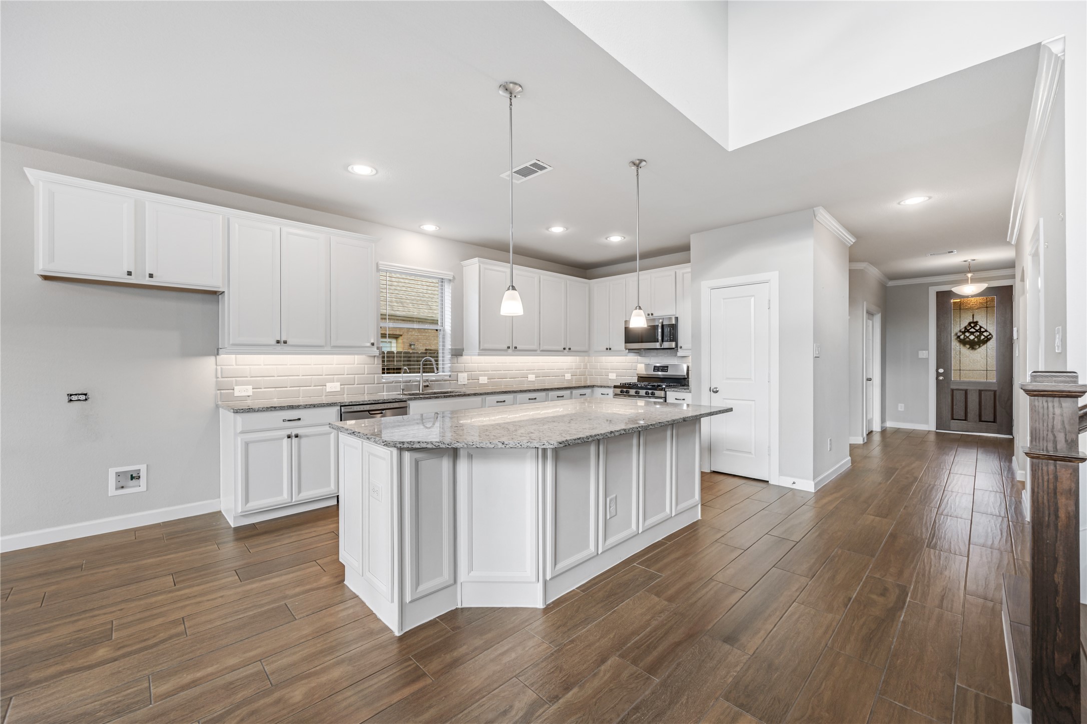 3604 Magnolia Crest Lane Spring, TX 77386 - Photo 13 of 50 a kitchen with stainless steel appliances granite countertop a stove top oven a sink dishwasher and a refrigerator with wooden floor